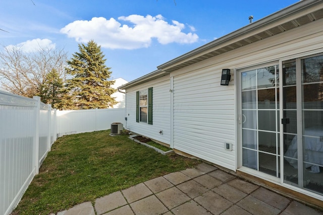 view of yard with a patio, a fenced backyard, and central AC