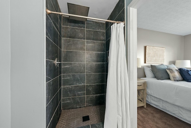 full bath featuring tiled shower and a textured ceiling