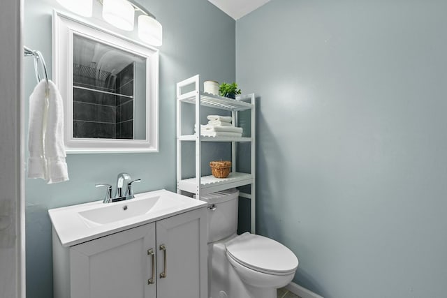 bathroom featuring toilet and vanity