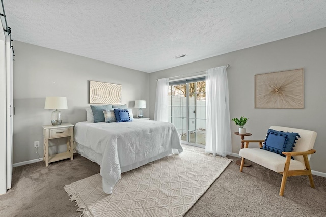 bedroom featuring a barn door, access to outside, baseboards, and light carpet