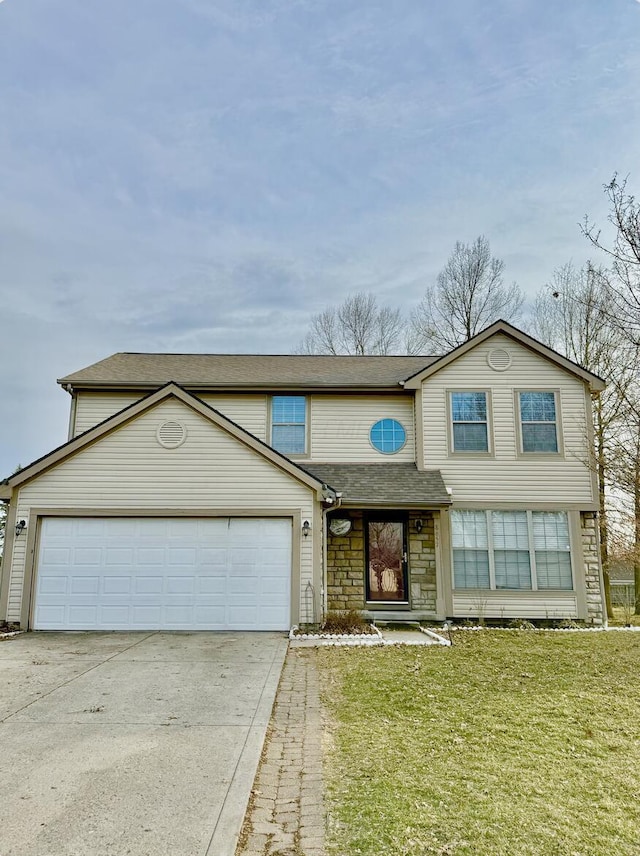 traditional-style house with a front yard, an attached garage, a shingled roof, concrete driveway, and stone siding