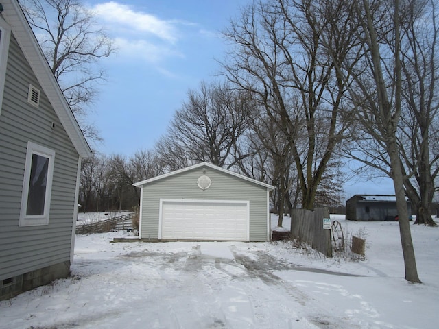 snow covered garage with a garage