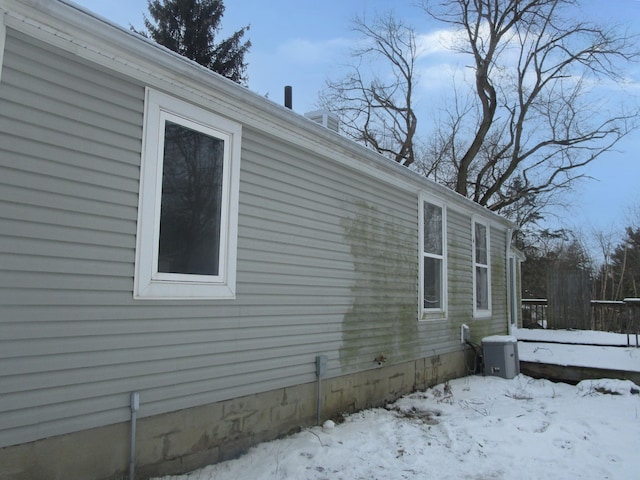 view of snowy exterior featuring crawl space