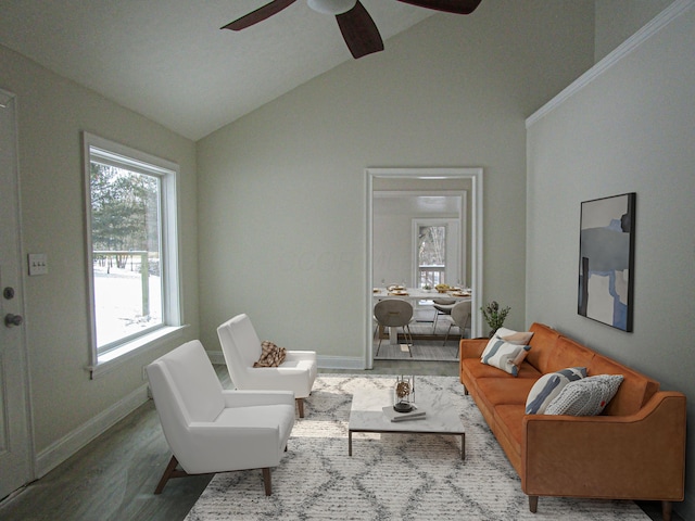 living room featuring ceiling fan, baseboards, lofted ceiling, and wood finished floors