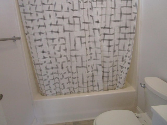 full bath featuring shower / bath combo with shower curtain and toilet