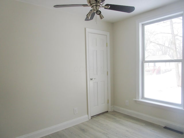 empty room featuring visible vents, baseboards, and light wood-style flooring