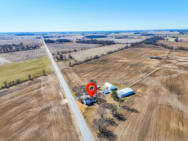 birds eye view of property with a rural view