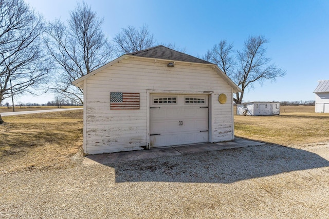 detached garage featuring driveway