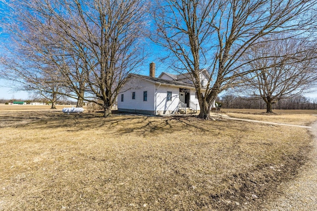 exterior space with a lawn and a chimney