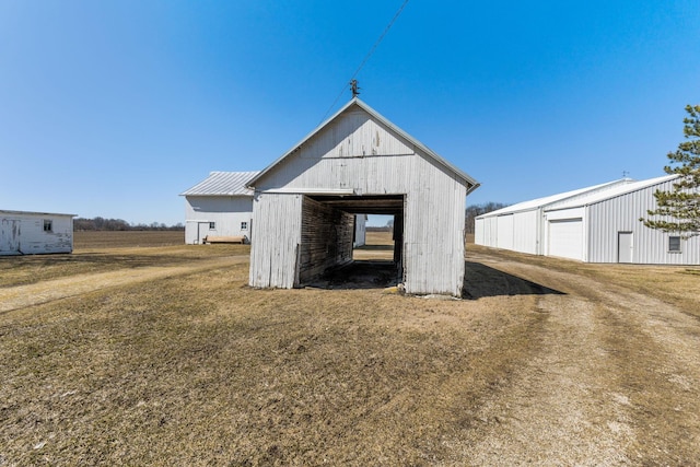 view of pole building with a yard