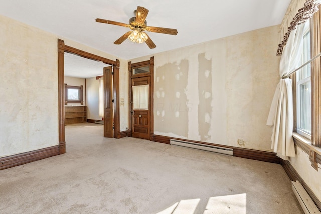 carpeted spare room with baseboards, baseboard heating, and a ceiling fan