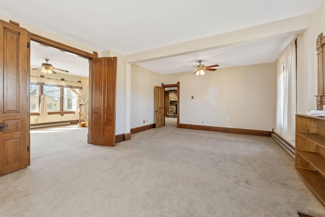 spare room featuring a baseboard radiator, light carpet, baseboards, and ceiling fan