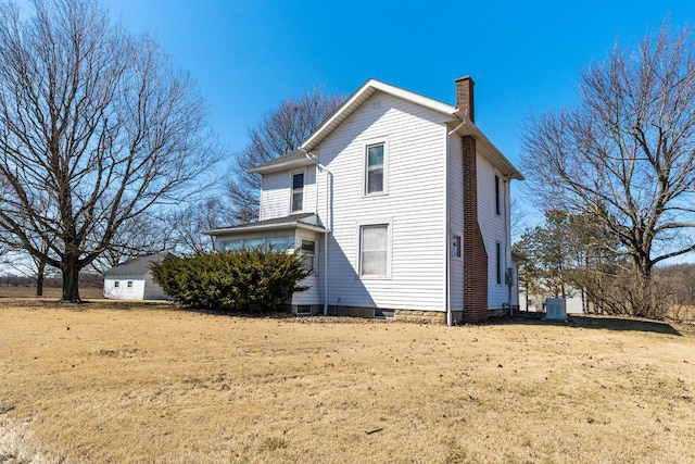 back of property featuring central air condition unit and a chimney