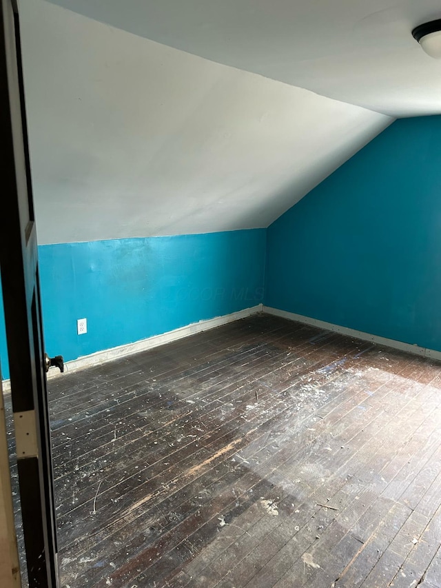 bonus room with lofted ceiling, baseboards, and hardwood / wood-style floors