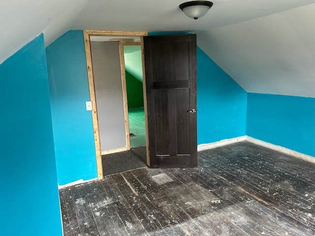 bonus room featuring vaulted ceiling, baseboards, and wood finished floors