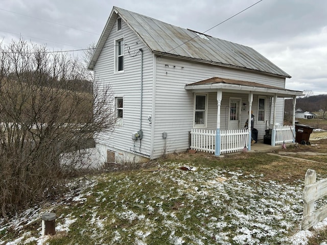 exterior space with covered porch and metal roof