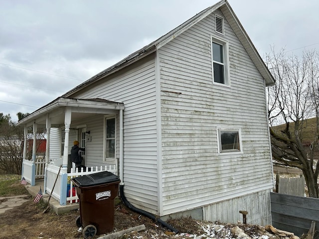 view of home's exterior with fence