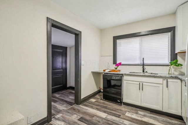 kitchen with dishwasher, light stone counters, wood finished floors, white cabinets, and a sink