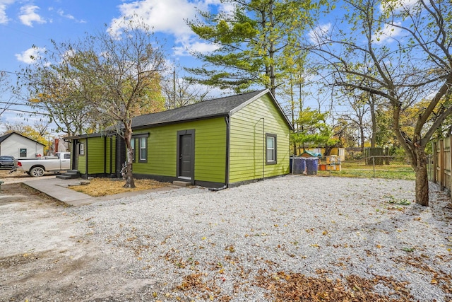 exterior space featuring fence, driveway, and entry steps