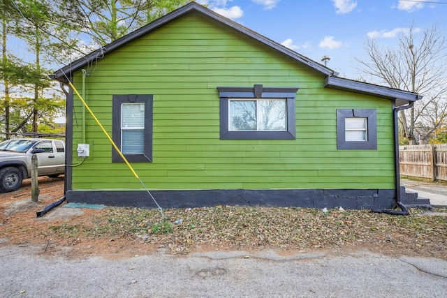 view of side of property featuring fence