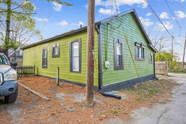 view of side of property featuring fence