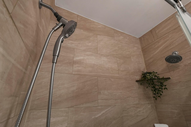 interior details featuring tiled shower