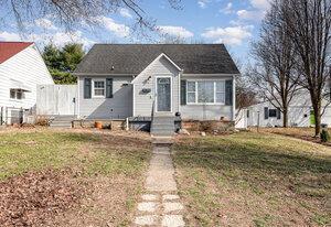 bungalow-style house featuring a front yard