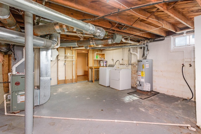 below grade area with gas water heater, heating unit, and separate washer and dryer