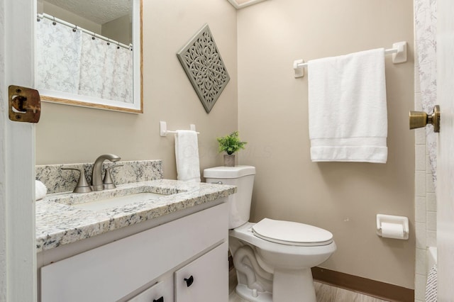 bathroom featuring curtained shower, baseboards, toilet, wood finished floors, and vanity