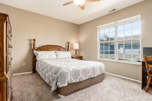 carpeted bedroom with a ceiling fan, visible vents, and baseboards