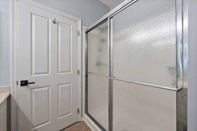 full bath with tile patterned flooring and a stall shower