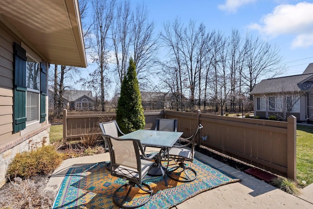 view of patio with outdoor dining area and fence