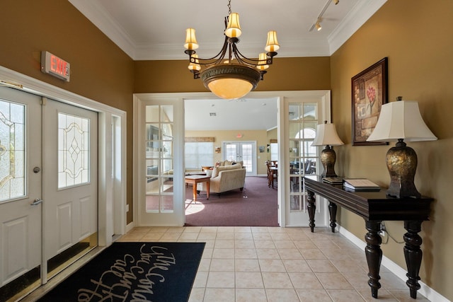 entryway featuring track lighting, crown molding, baseboards, french doors, and light tile patterned flooring