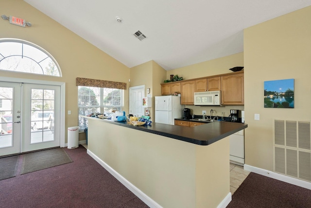 kitchen featuring visible vents, white appliances, dark countertops, and french doors