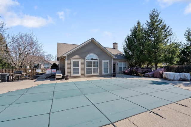 view of swimming pool featuring a fenced in pool, a patio, and fence