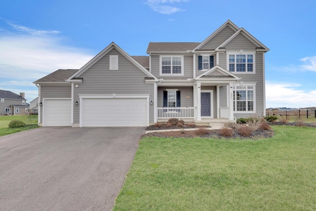 view of front of house featuring a porch, driveway, a garage, and a front lawn