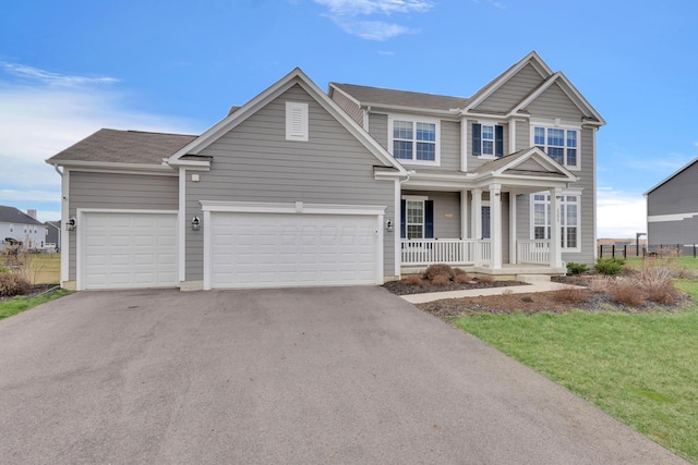 view of front of property with a porch, driveway, and an attached garage