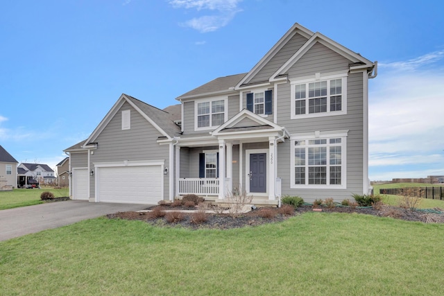 traditional home with a front yard, concrete driveway, a garage, and covered porch