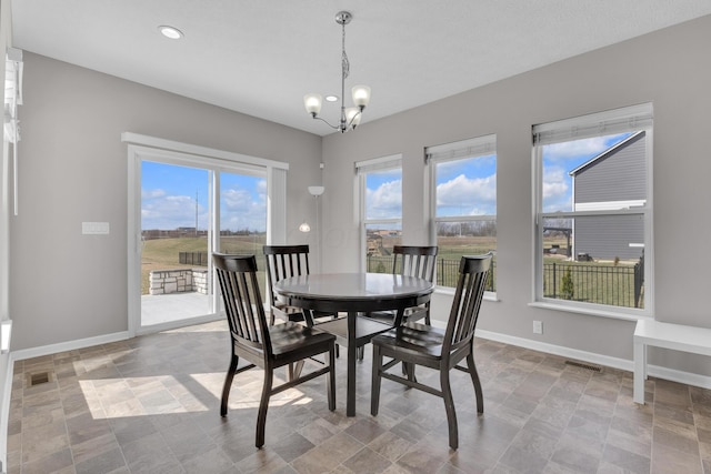 dining room featuring baseboards, visible vents, a chandelier, and recessed lighting