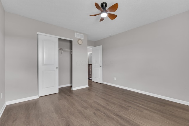 unfurnished bedroom with visible vents, baseboards, a closet, and wood finished floors