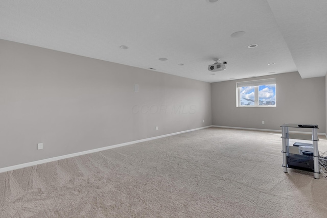 carpeted spare room with baseboards