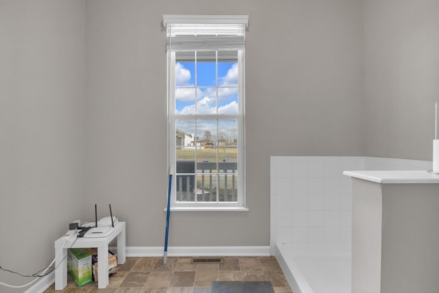 interior space with baseboards and visible vents