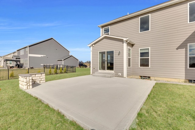back of house featuring fence, a lawn, entry steps, and a patio