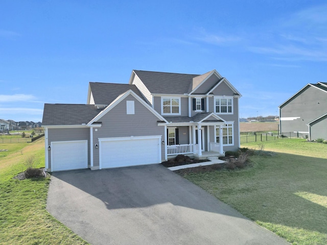 view of front of home featuring covered porch, fence, aphalt driveway, a front lawn, and a shingled roof
