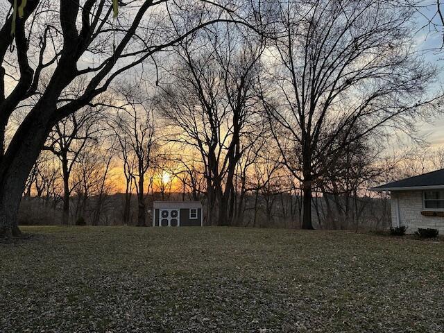 view of yard at dusk