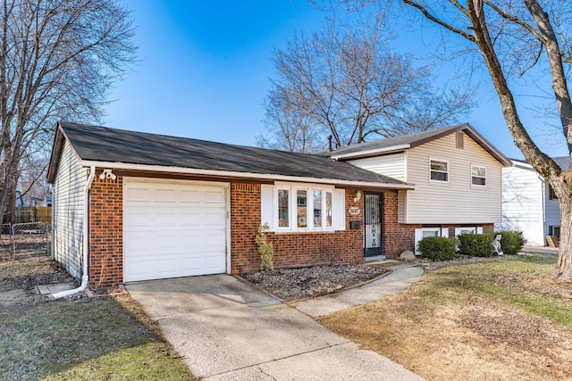 split level home featuring fence, driveway, an attached garage, a shingled roof, and brick siding