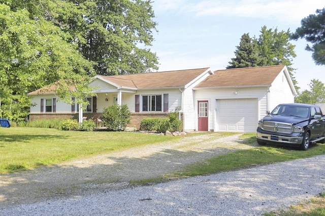 single story home featuring brick siding, a garage, a front lawn, and dirt driveway