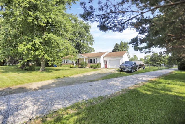 view of front facade with a garage, a front yard, and driveway