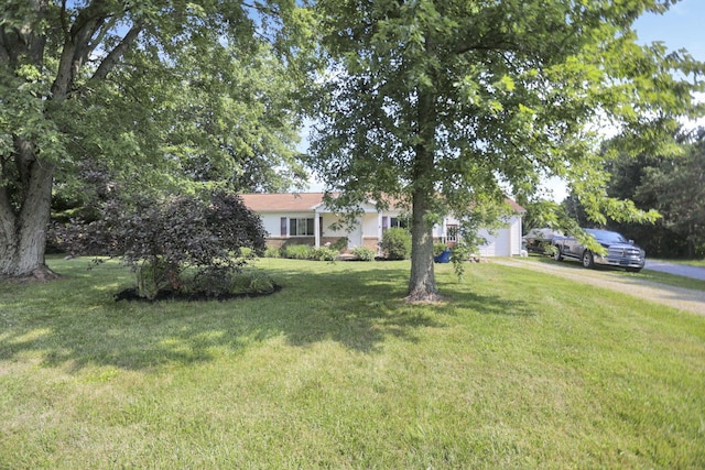 view of front of home with a front lawn, an attached garage, and driveway