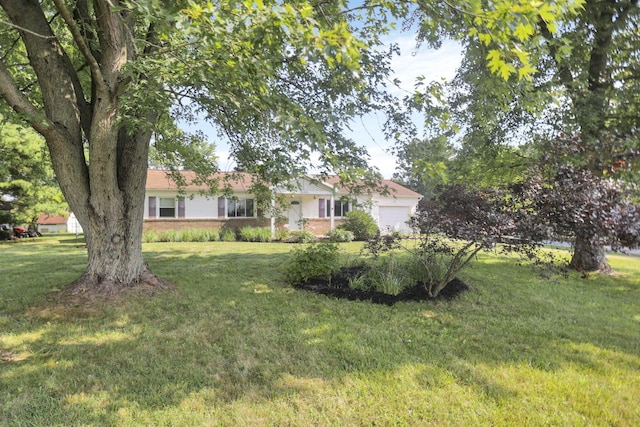 view of front of property with a front yard and a garage